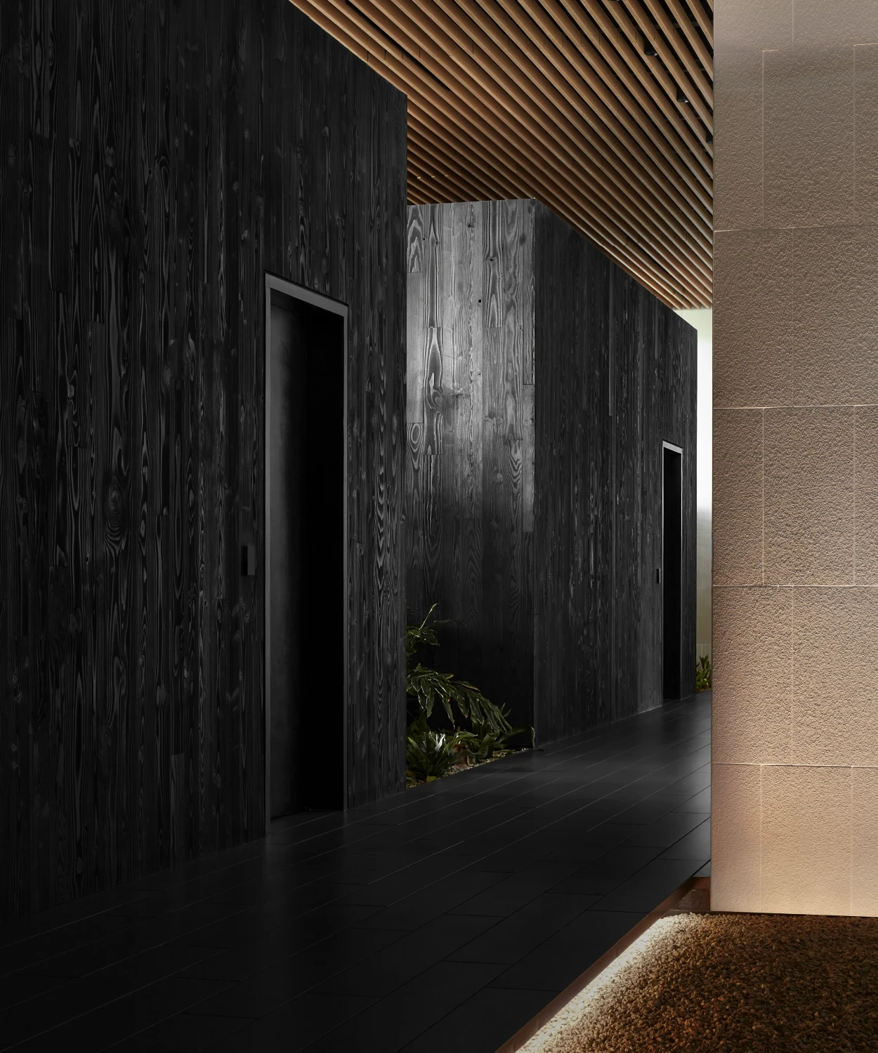 Clinic entrance hallway with black stone walls